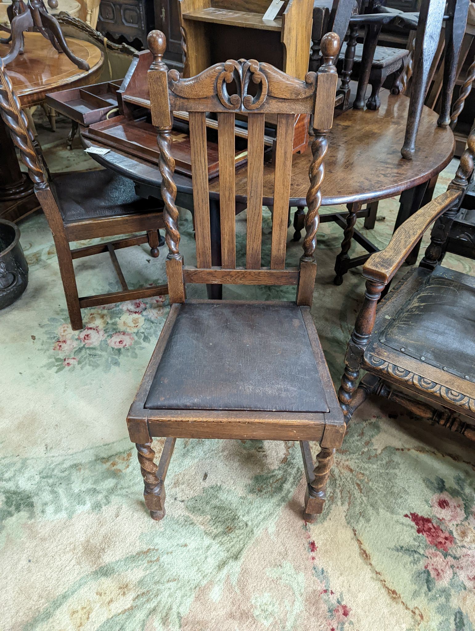 A harlequin set of six early 20th century oak dining chairs, two with arms